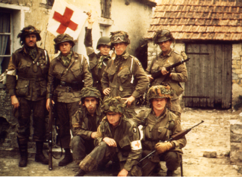 Kodachrome slide taken by Captain George Lage in Normandy. Lage was 2nd battalion surgeon of the 502 PIR, and he posed here with some of his medics.Note the German belt and buckle and Mauser rifle.jpg