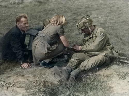 A trooper of the 101st, along with three Dutch civilians, sitting somewhere in the fields of the Netherlands..jpg