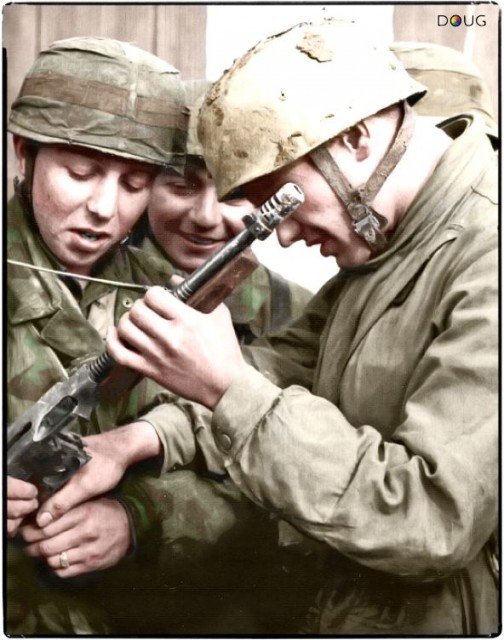 A group of Fallschirmjäger (German paratroopers) are examining a captured M1928A1 Thompson ..jpg
