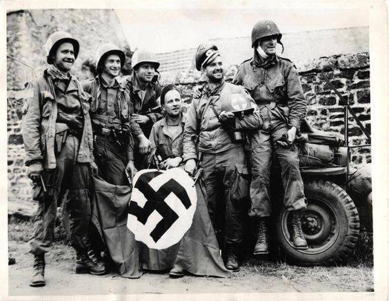 1944 - 3rd Battalion, 508th PIR, 82nd Abn Div medics, captured during D-Day invasion, display their souvenirs after being liberated by comrades in Orglandes, France..jpg