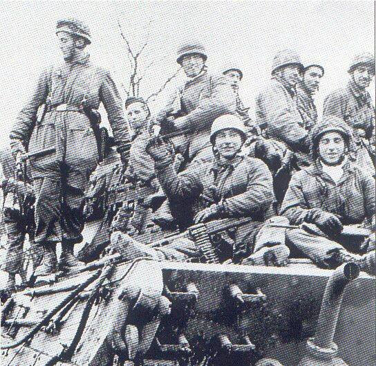 Ardennes Offensive, Fallschirmjäger on left with British Sten gun..jpg